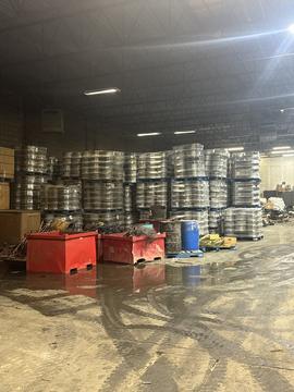 Scrap Metal Recycling Warehouse with Stacked Aluminum Wheels