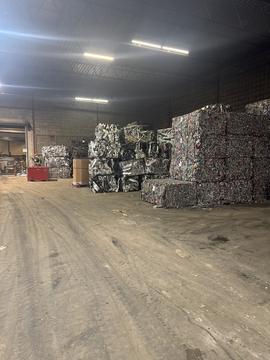 Scrap Metal Recycling Facility with Stacked Bales and Industrial Equipment